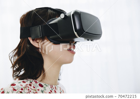 A woman watching VR A woman watching VR 70472215