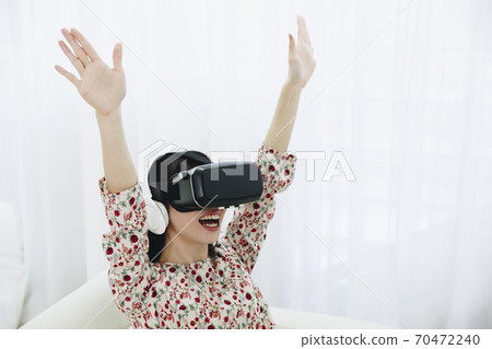 A woman watching VR A woman watching VR 70472240