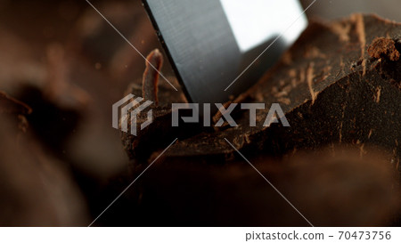 Detail of chisel cutting off raw chocolate Detail of chisel cutting off raw chocolate 70473756