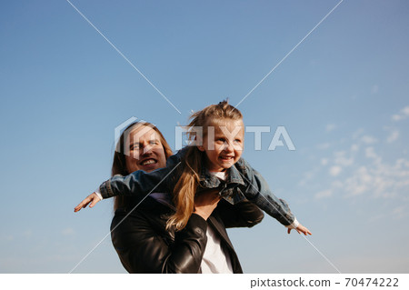 Cheerful father playing with little daughter outdoors 70474222