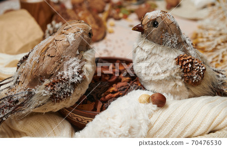christmas decoration in rustic style and holiday background, still life on wooden backdrop, a stuffed bird and other christmas decoration in rustic style and holiday background, still life on wooden backdrop, a stuffed bird and other 70476530