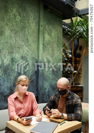 People using gadgets in cafe 70476867