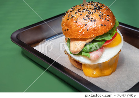 Close up tasty burger with different filling served on tray 70477409
