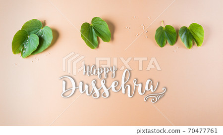 Happy Dussehra. Green leaf on orange pastel background. Dussehra Indian Festival concept. 70477761