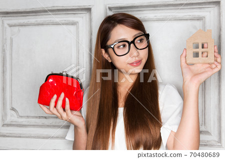 Woman with purse and house 70480689