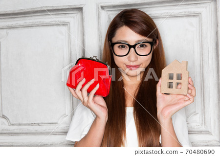 Woman with purse and house 70480690