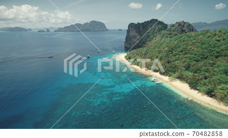 Cruise at tropical sea coast on boats, ships. Tourists relax, swim at shallow water near coastline 70482858