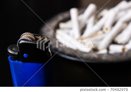 Lighter and ashtray on a wooden table Lighter and ashtray on a wooden table 70482978