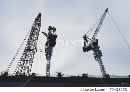 Building construction looking up and multiple cranes towering in the sky b-3 Matte feeling 70483976
