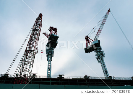 Building construction looking up and multiple cranes towering in the sky b-4 Cyan 70483978