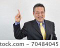 A businessman in his 60s who is enthusiastic about explaining 70484045