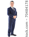 A businessman standing on a white background with his whole body 70484178