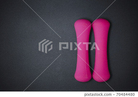Pink dumbbells on black background, sport and fitness concept. 70484480