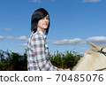 young beautiful brunette woman riding horse 70485076