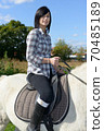 young beautiful brunette woman riding horse 70485189