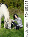 young rider girl with her white horse 70485195