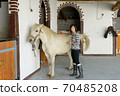 Beautiful young girl and white horse 70485208