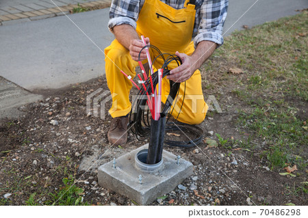 Fiber optic cable lines installation at street 70486298