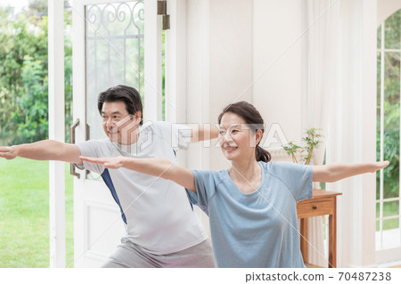 Senior men doing room yoga refrain from going out 70487238