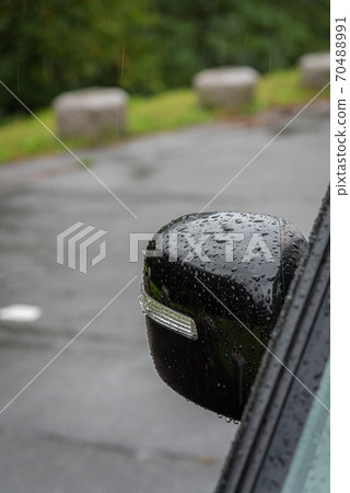 Side mirror of a car wet in the rain Side mirror of a car wet in the rain 70488991