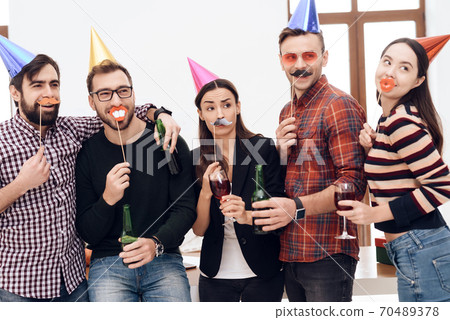 Cheerful people celebrate office party together. Cheerful people celebrate office party together. 70489378