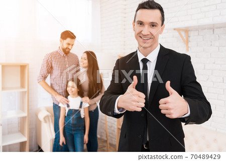 A young family stands behind a realtor. A young family stands behind a realtor. 70489429
