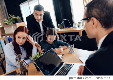 Man asks woman to sign document in lawyer office. Man asks woman to sign document in lawyer office. 70489453