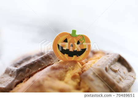 Homemade pumpkin muffins with Halloween picks 70489651