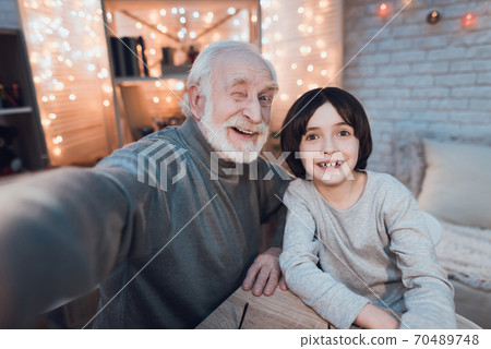 Grandfather and grandson are taking selfie. Grandfather and grandson are taking selfie. 70489748