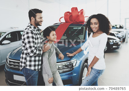 Father, mother and son near new car. Father, mother and son near new car. 70489765