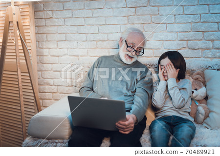 Grandfather and grandson are watching movie. Grandfather and grandson are watching movie. 70489921