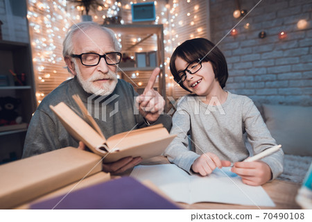 Grandson smiled while doing homework. Grandson smiled while doing homework. 70490108