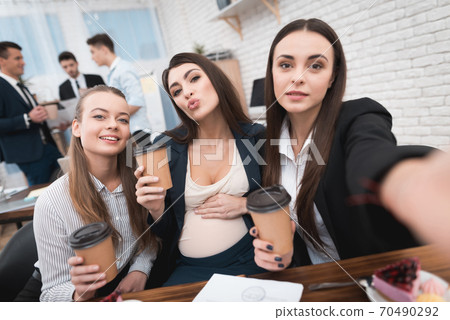 Girls sit at the table and take a beautiful photo. 70490292