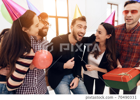 Corporate people having fun with cones on heads. Corporate people having fun with cones on heads. 70490331