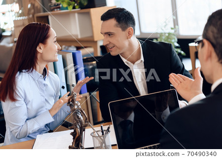 Family lawyer listens to a couple who communicates Family lawyer listens to a couple who communicates 70490340