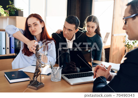 Woman tearing paper while sitting at a table. Woman tearing paper while sitting at a table. 70490343