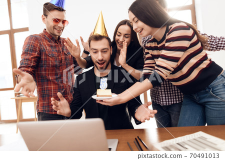Girl holding a piece of cake with a candle. Girl holding a piece of cake with a candle. 70491013