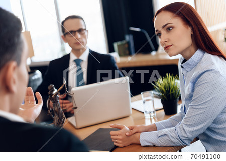 Woman looks at ex husband in lawyer office. 70491100