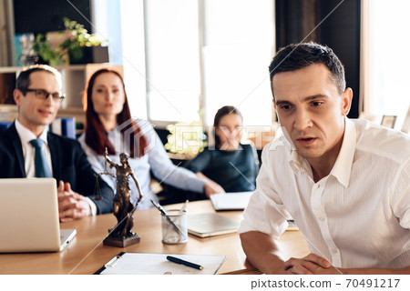 Tired man sitting in a shirt at the lawyer office. Tired man sitting in a shirt at the lawyer office. 70491217