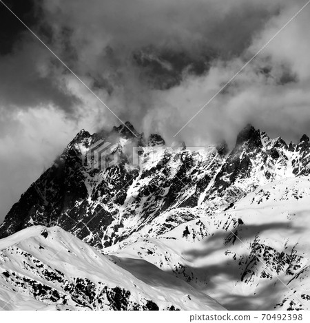 Black and white snowy rocks in haze at sunny day Black and white snowy rocks in haze at sunny day 70492398