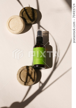 Spray bottle with green space for brand and solid bars of soap. 70493724
