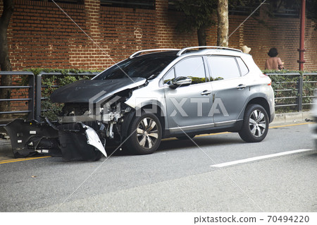 A car parked on the side of the road after a traffic accident 70494220