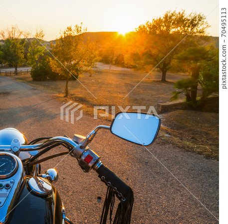 Motorcycle on a country road at sunset Motorcycle on a country road at sunset 70495113