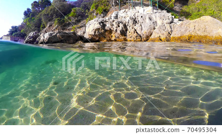 Split underwater view of Sardinia colorful shore 70495304