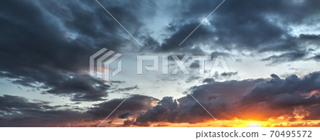 Dark clouds and bright sun 70495572