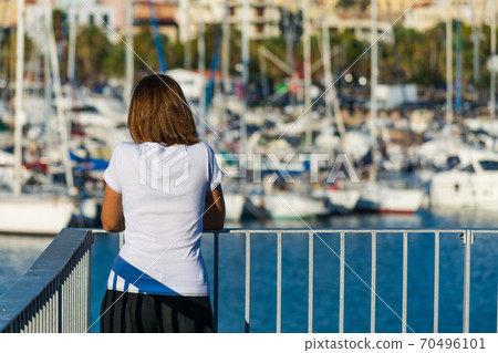 Girl looking at the harbor 70496101