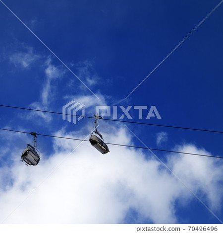Chair-lift and sunlight evening sky 70496496