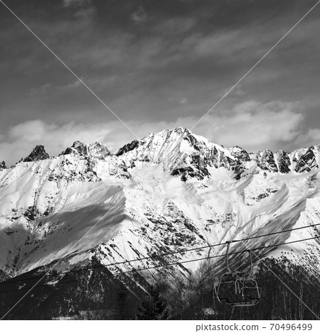 Black and white ski lift in snow mountains at nice winter day Black and white ski lift in snow mountains at nice winter day 70496499