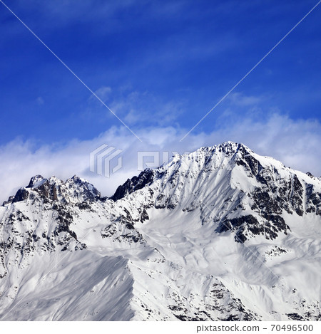 Snow mountains in winter sun day and blue sky with clouds Snow mountains in winter sun day and blue sky with clouds 70496500