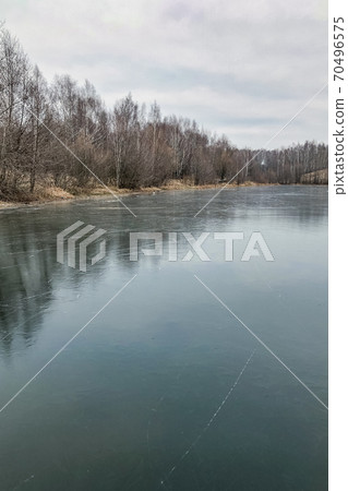 Clear blue surface of frozen lake water with a thin scratch pattern Clear blue surface of frozen lake water with a thin scratch pattern 70496575